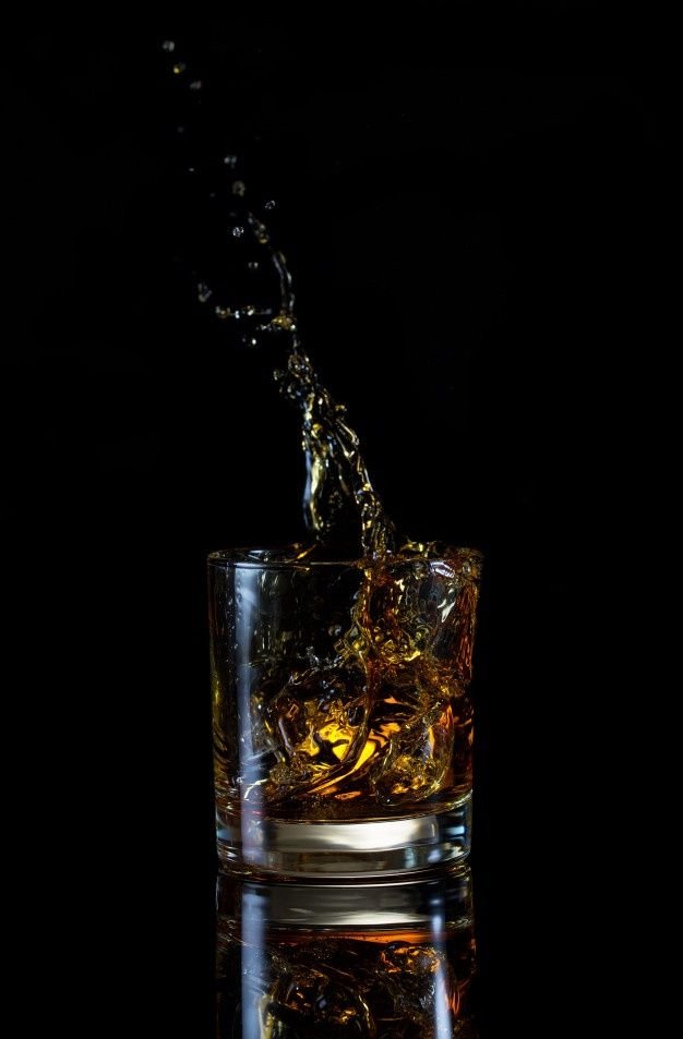 Alto chapoteo en vaso de whisky _ Foto Premium